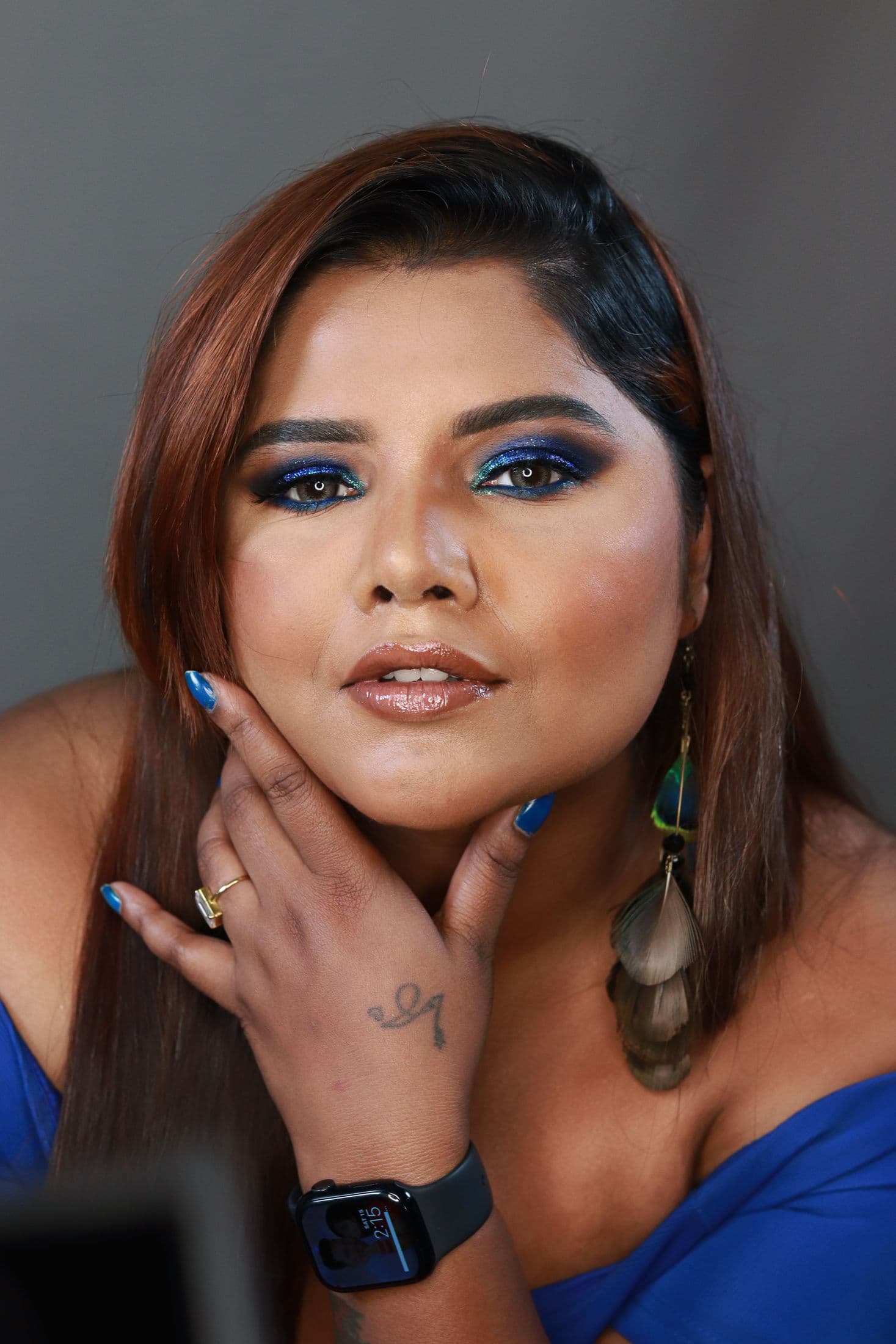 Close-up portrait with cobalt shimmer eyes, glossy nude lips and blue styling
